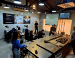 Profissionais do setor da construção civil assistem a uma apresentação no 5º Café com Patrocinadores do C3, em ambiente moderno e colaborativo.